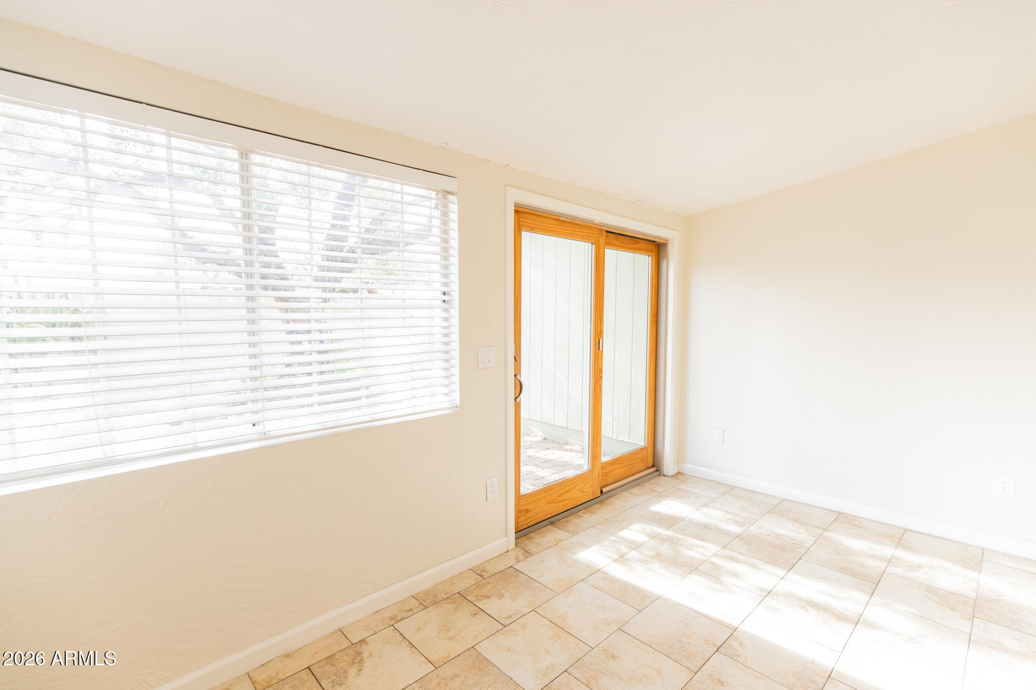 1029 West Elna Rae Street Tempe, AZ 85281 - Photo 7 of 20 a view of an empty room with a window