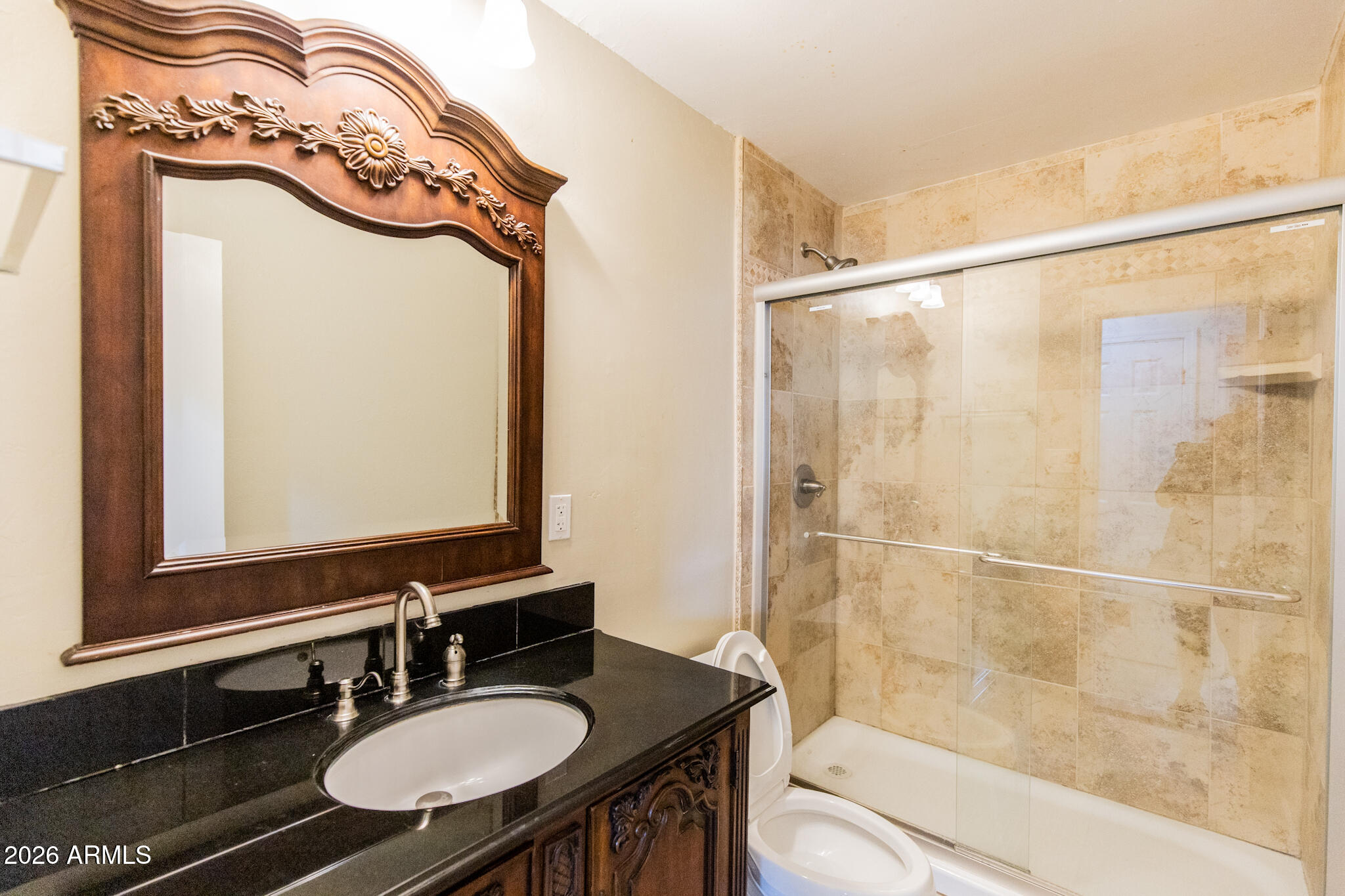 1029 West Elna Rae Street Tempe, AZ 85281 - Photo 9 of 20 a bathroom with a sink a mirror a bathtub and a shower