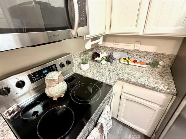 a kitchen with a stove top oven and a sink
