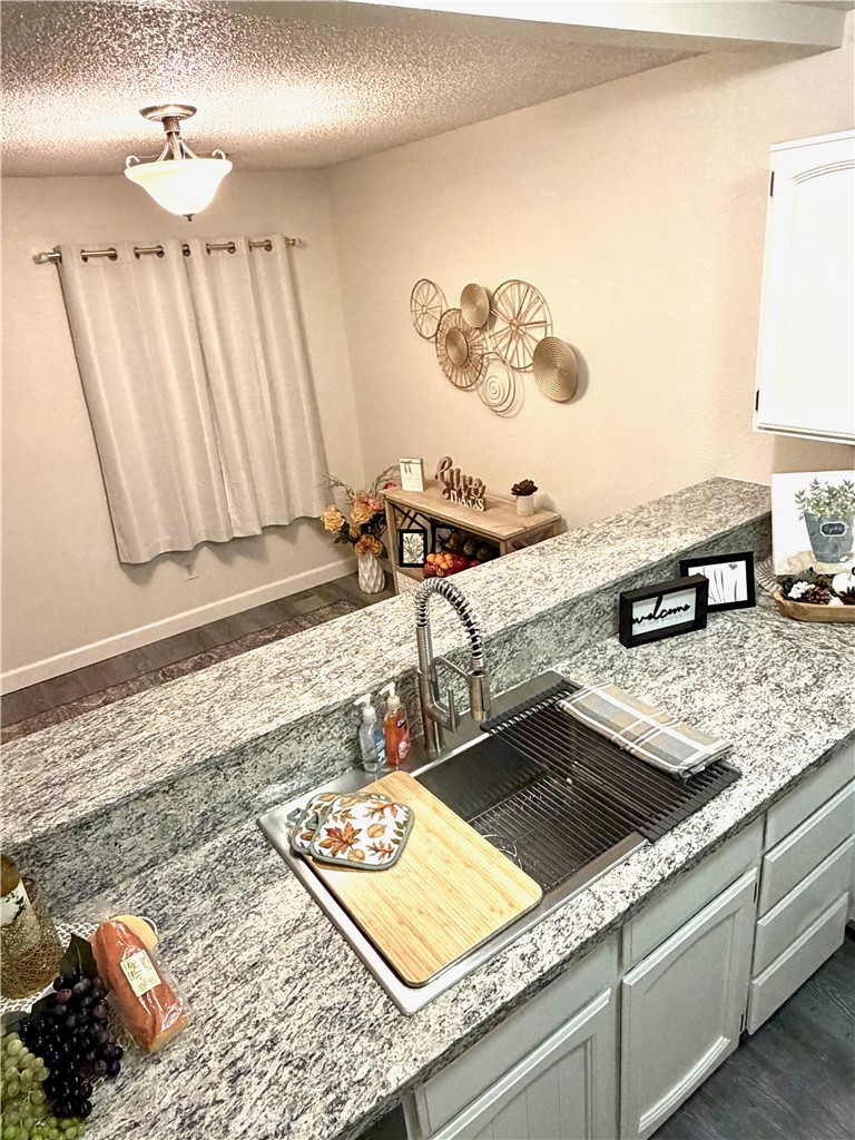 3400 Sullivan Court, Unit 105 Modesto, CA 95356 - Photo 15 of 46 a kitchen with a sink and a stove with wooden floor