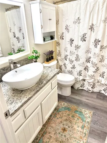 a bathroom with a toilet and a mirror