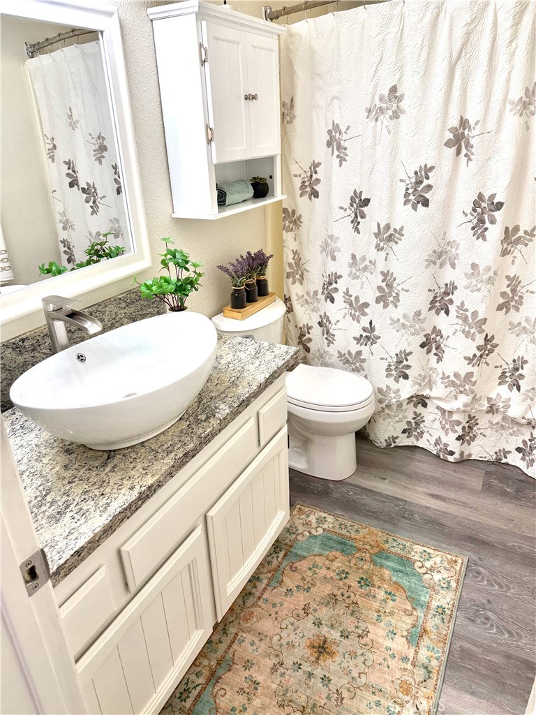 3400 Sullivan Court, Unit 105 Modesto, CA 95356 - Photo 31 of 46 a bathroom with a granite countertop sink and a mirror