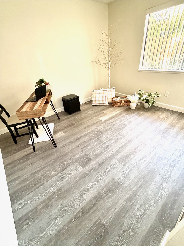 3400 Sullivan Court, Unit 105 Modesto, CA 95356 - Photo 33 of 46 a room with wooden floor and furniture