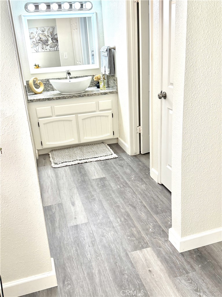 3400 Sullivan Court, Unit 105 Modesto, CA 95356 - Photo 38 of 46 a bathroom with a granite countertop sink and a mirror
