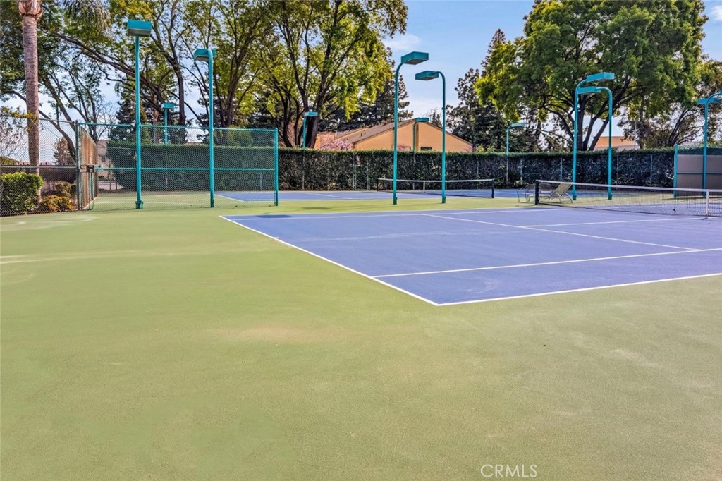 3400 Sullivan Court, Unit 105 Modesto, CA 95356 - Photo 43 of 46 a view of a tennis ground with large trees