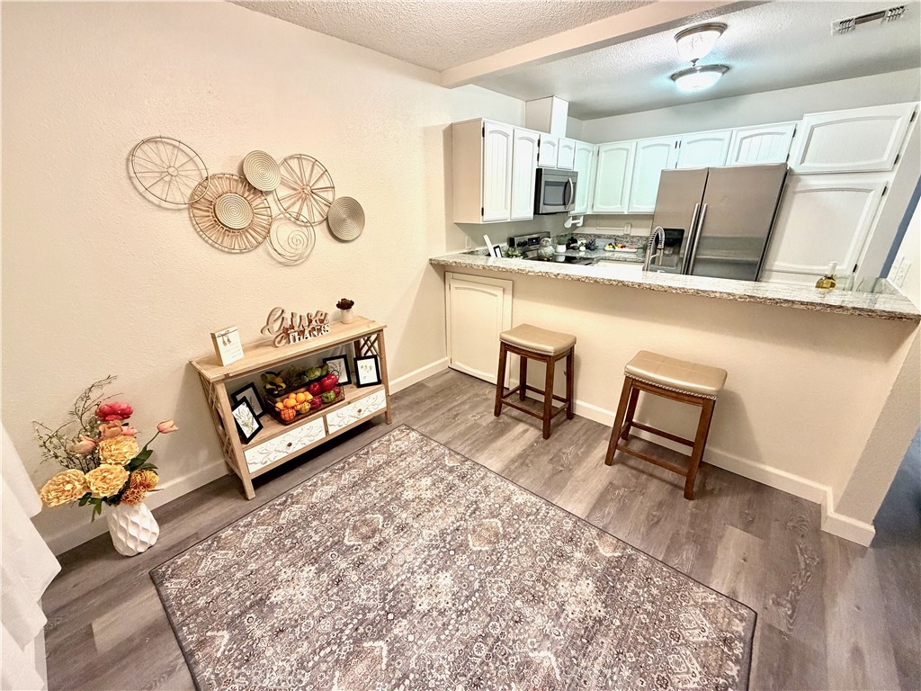 3400 Sullivan Court, Unit 105 Modesto, CA 95356 - Photo 6 of 46 a living room with hard wood floor and a table