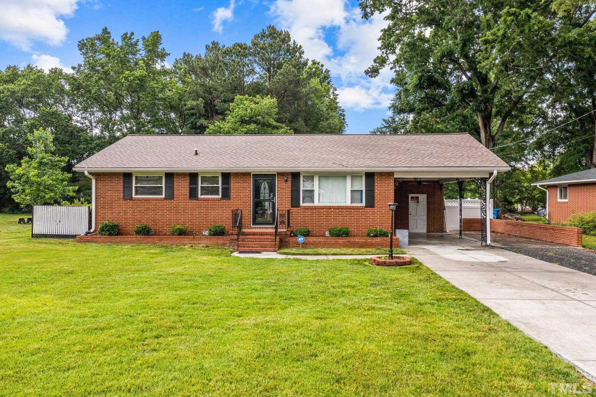 2533 Ross Road Durham, NC 27703 - Photo 3 of 33 a front view of a house with a garden and trees