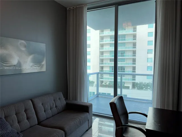 a living room with furniture and a window