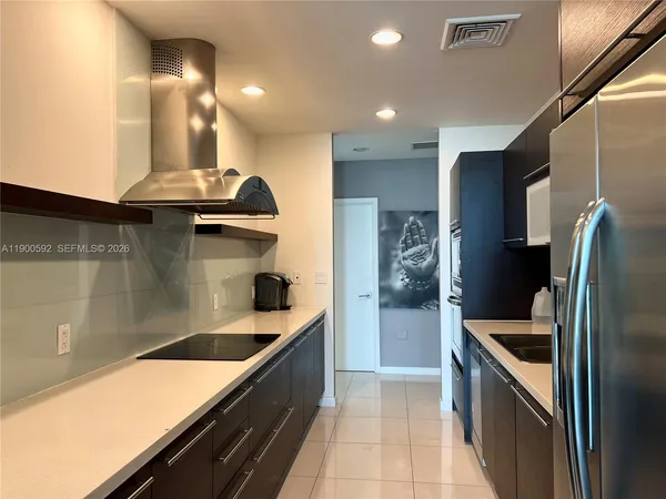 a kitchen with stainless steel appliances granite countertop a sink and stove