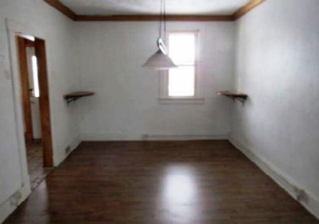 409 Vine Street Homestead, PA 15120 - Photo 4 of 10 an empty room with wooden floor and windows