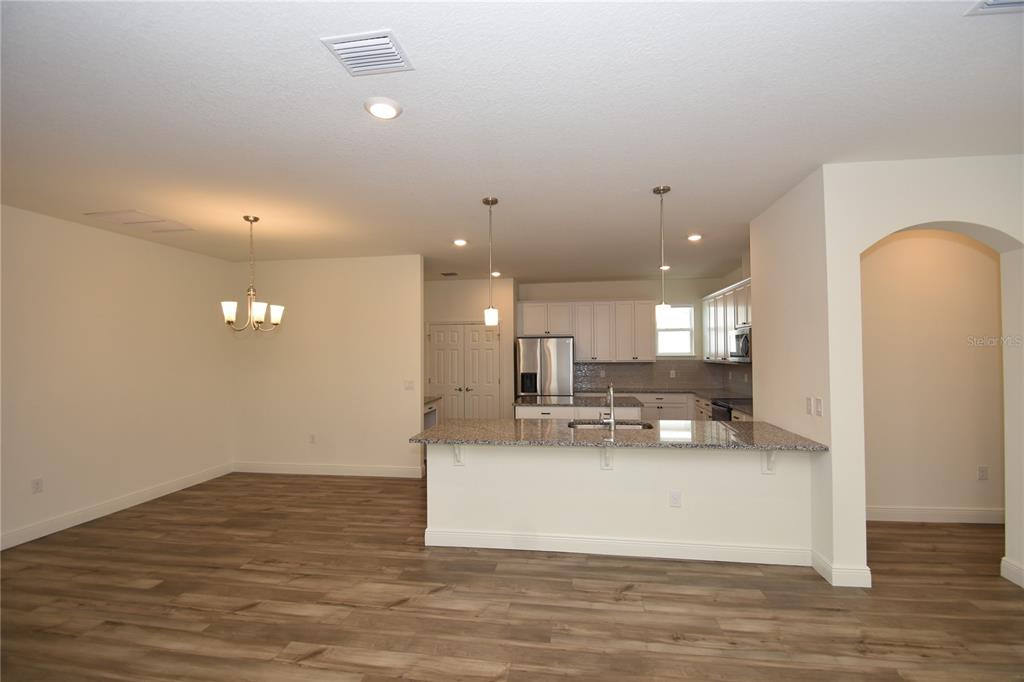 59 Oakleaf Way Palm Coast, FL 32137 - Photo 12 of 39 a view of kitchen and kitchen island with wooden floor