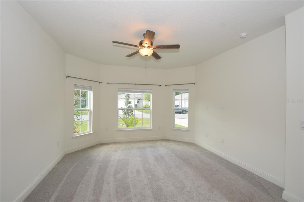 59 Oakleaf Way Palm Coast, FL 32137 - Photo 17 of 39 an empty room with windows and ceiling fan