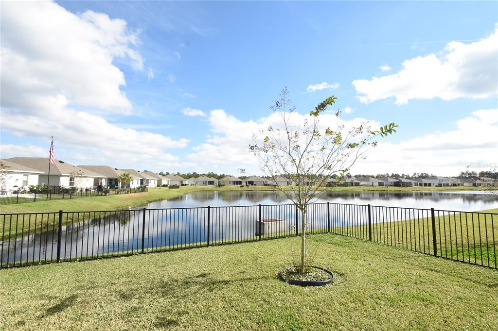59 Oakleaf Way Palm Coast, FL 32137 - Photo 2 of 39 a view of a lake with a garden