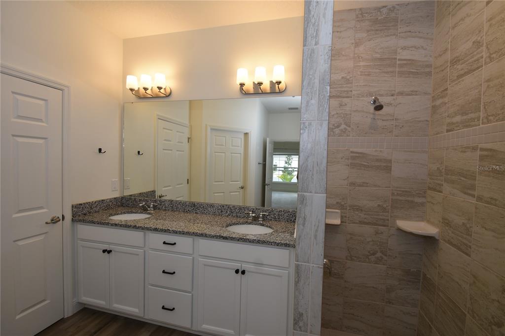 59 Oakleaf Way Palm Coast, FL 32137 - Photo 21 of 39 a bathroom with a granite countertop sink and a mirror