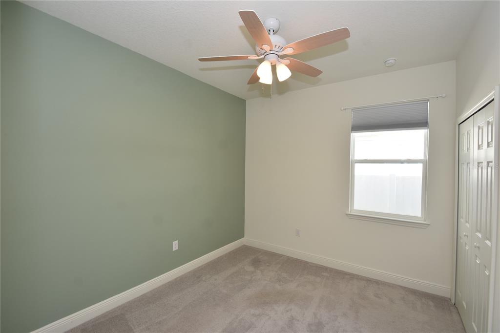 59 Oakleaf Way Palm Coast, FL 32137 - Photo 27 of 39 an empty room with a chandelier fan and a window