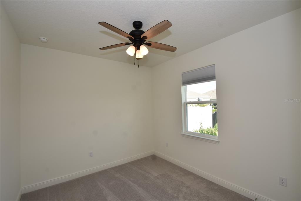 59 Oakleaf Way Palm Coast, FL 32137 - Photo 32 of 39 an empty room with windows and fan