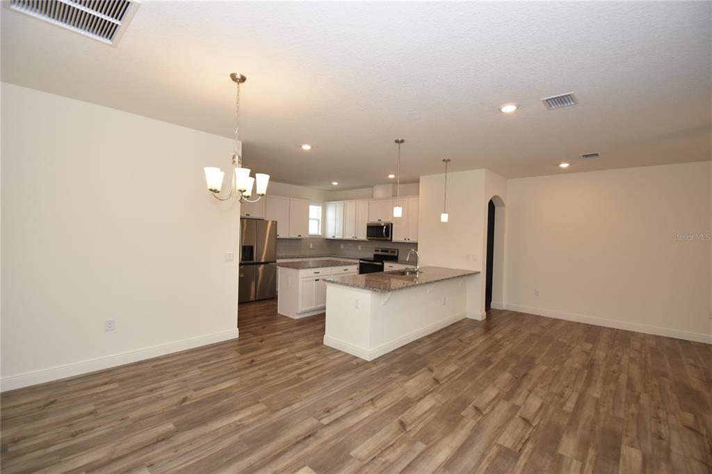 59 Oakleaf Way Palm Coast, FL 32137 - Photo 5 of 39 a large kitchen with a lot of cabinets and stainless steel appliances