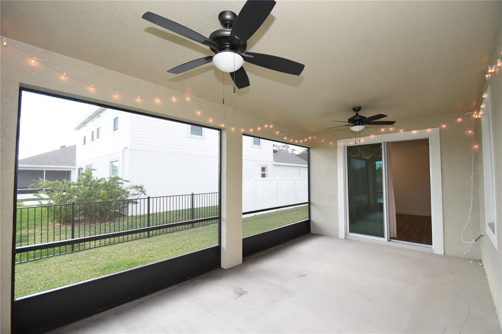 59 Oakleaf Way Palm Coast, FL 32137 - Photo 10 of 39 an empty room with sliding door and a chandelier fan