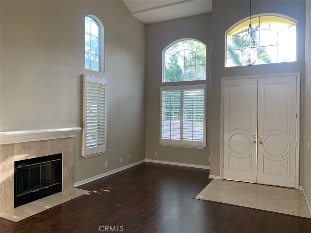 359 California Street Arcadia, CA 91006 - Photo 4 of 24 an empty room with wooden floor fireplace and windows