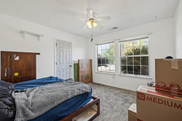 a bedroom with a bed and a chandelier