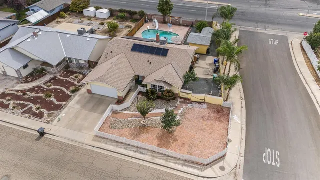 an aerial view of a house with a yard