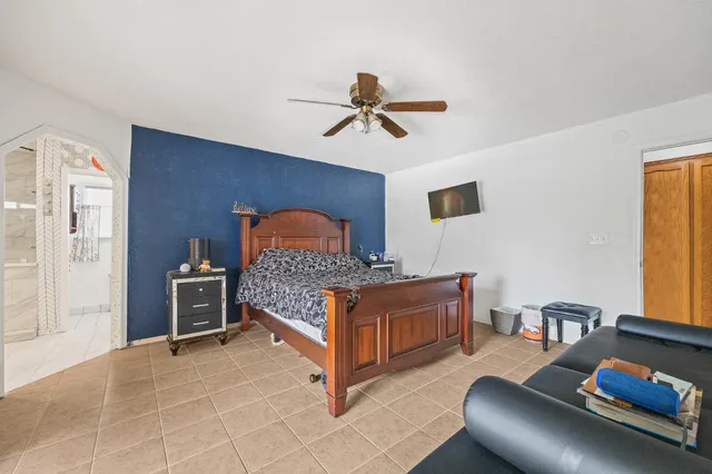 a bedroom with furniture and a window