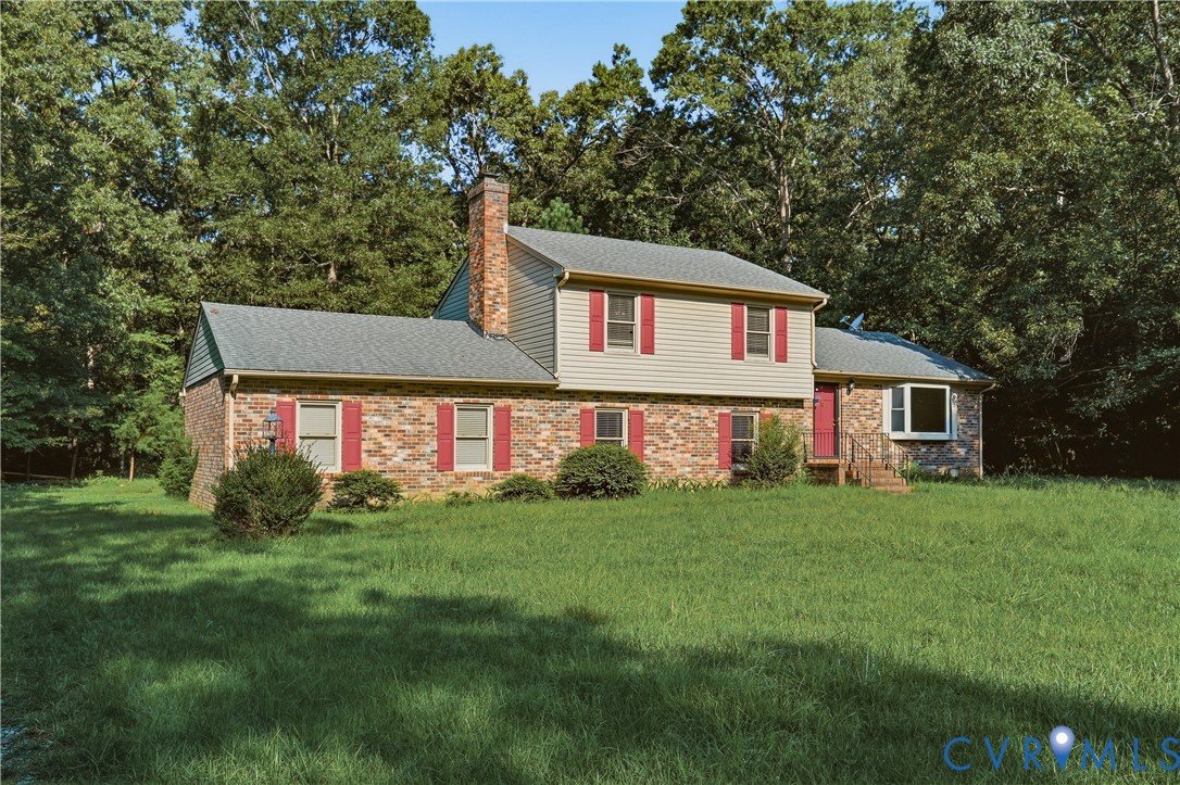 Brick and siding exterior with red shutters, featu