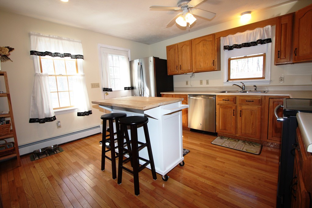 28 Dodge Hill Road Sutton, MA 01590 - Photo 3 of 18 a kitchen with granite countertop wooden floors and wooden cabinets