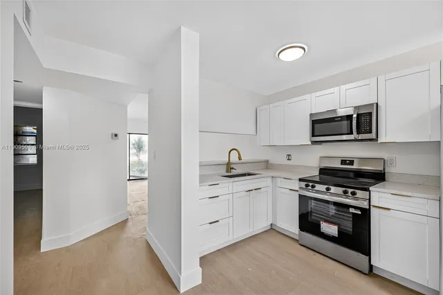 a kitchen with a sink stove and microwave