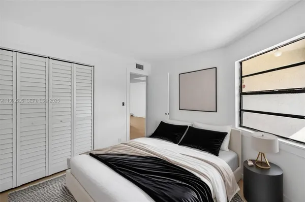 a bedroom with a bed and a window