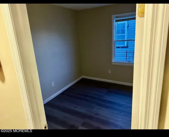 a view of front door with wooden floor