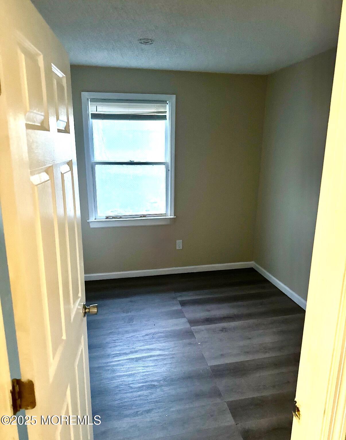 39 Sampson Avenue, Unit 7 Seaside Heights, NJ 08751 - Photo 5 of 6 a view of an empty room and wooden floor