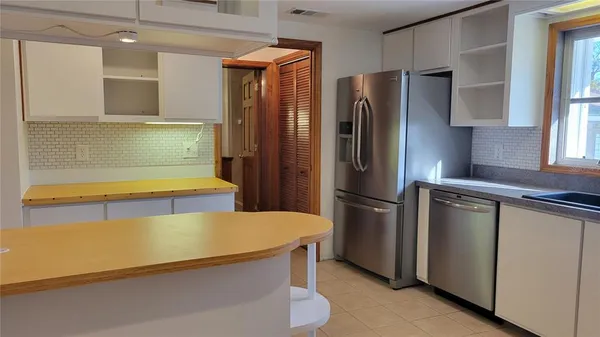 a kitchen with stainless steel appliances a refrigerator and a stove