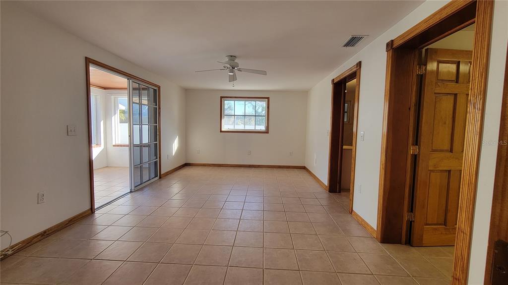 5847 Venisota Road Venice, FL 34293 - Photo 13 of 29 a view of an empty room with glass door and windows