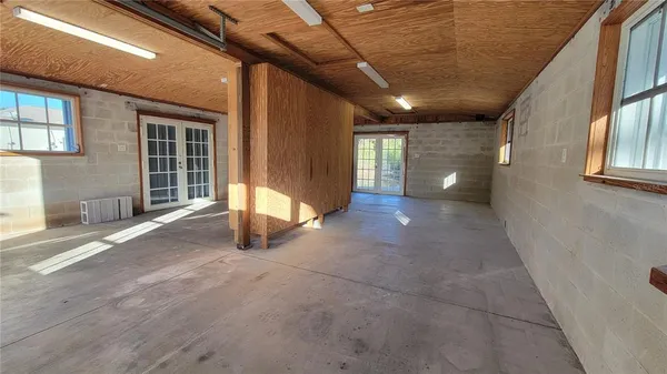 a view of a hallway with wooden floor and fence