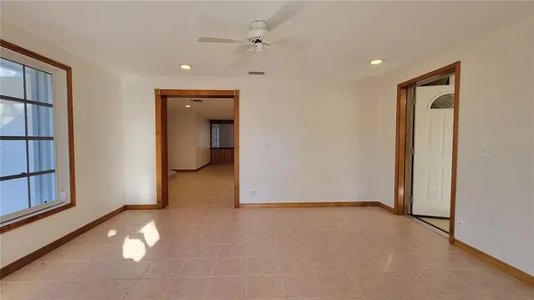 an empty room with closet and windows