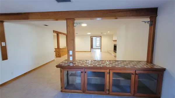 a view of living room with granite countertop wooden floor and clock