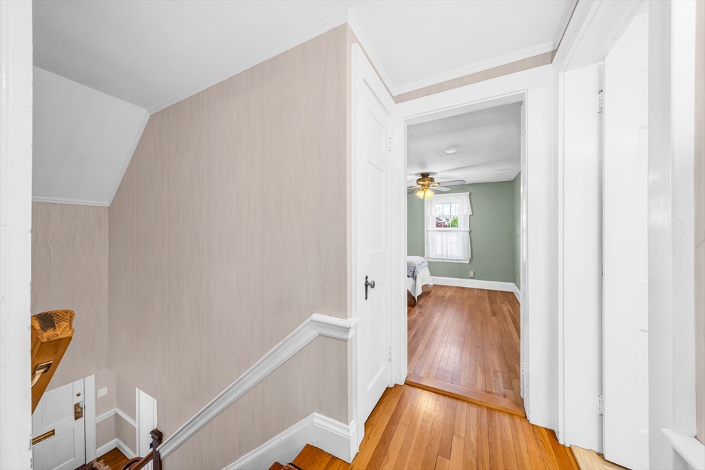 293 Florence Road Waltham, MA 02453 - Photo 20 of 41 a view of a hallway with wooden floor and cabinet