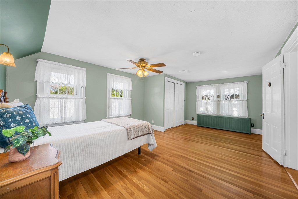 293 Florence Road Waltham, MA 02453 - Photo 23 of 41 a bedroom with a bed and a potted plant
