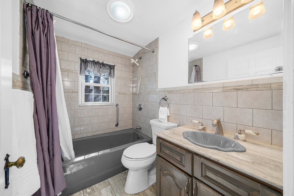 293 Florence Road Waltham, MA 02453 - Photo 25 of 41 a bathroom with a granite countertop sink toilet and shower