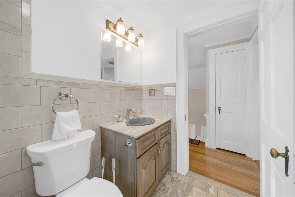 293 Florence Road Waltham, MA 02453 - Photo 26 of 41 a bathroom with a toilet a sink and mirror