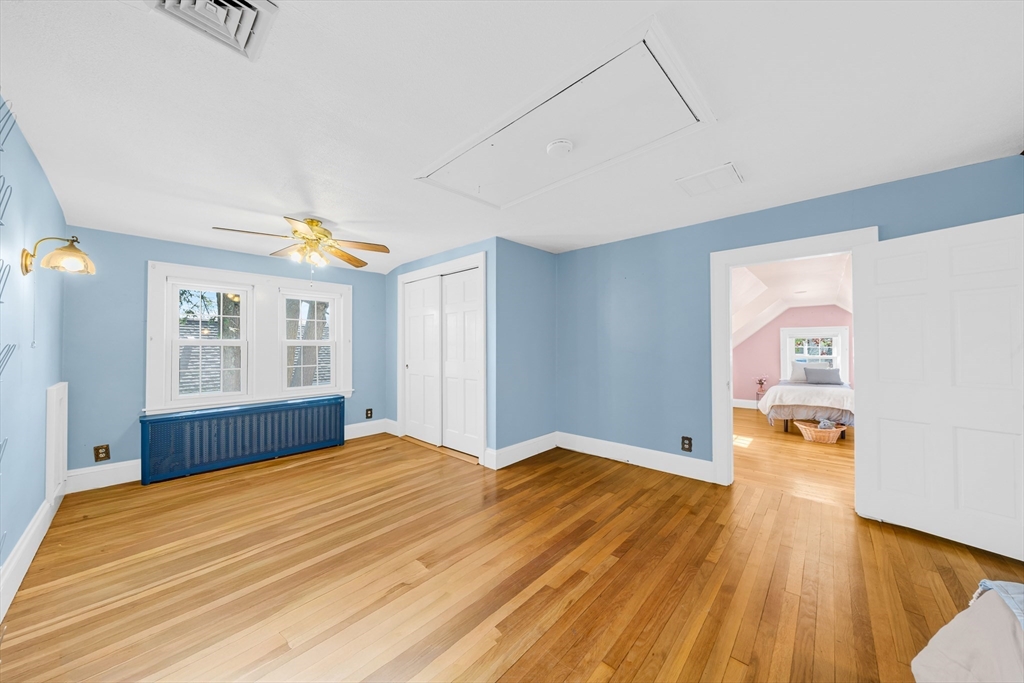 293 Florence Road Waltham, MA 02453 - Photo 29 of 41 a bedroom with a bed and wooden floor