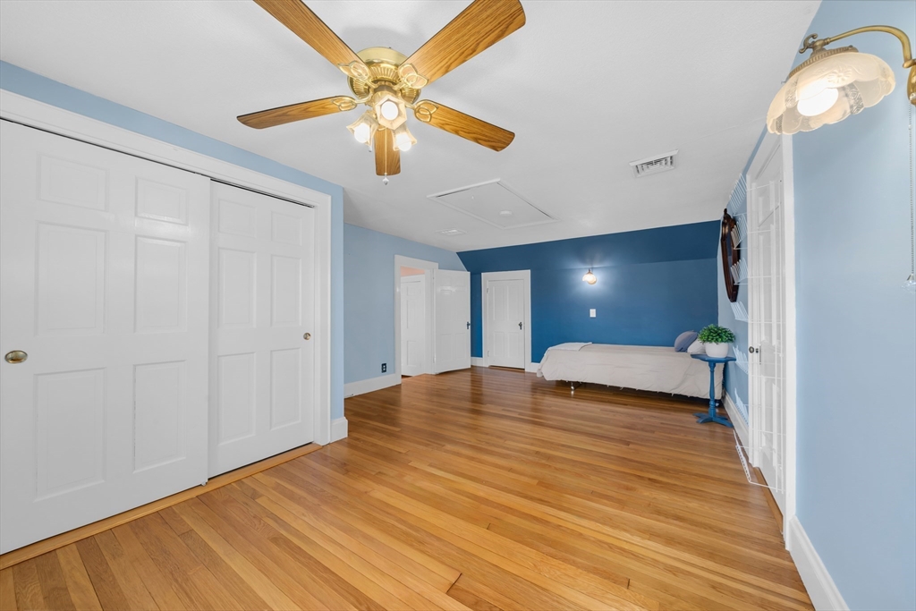293 Florence Road Waltham, MA 02453 - Photo 30 of 41 a bedroom with a bed and a chandelier