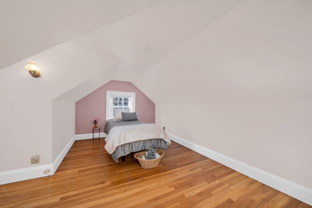 293 Florence Road Waltham, MA 02453 - Photo 31 of 41 a bedroom with a bed and a wooden floor