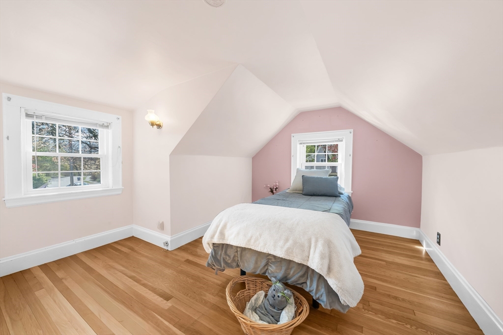 293 Florence Road Waltham, MA 02453 - Photo 32 of 41 a bedroom with a bed and wooden floor