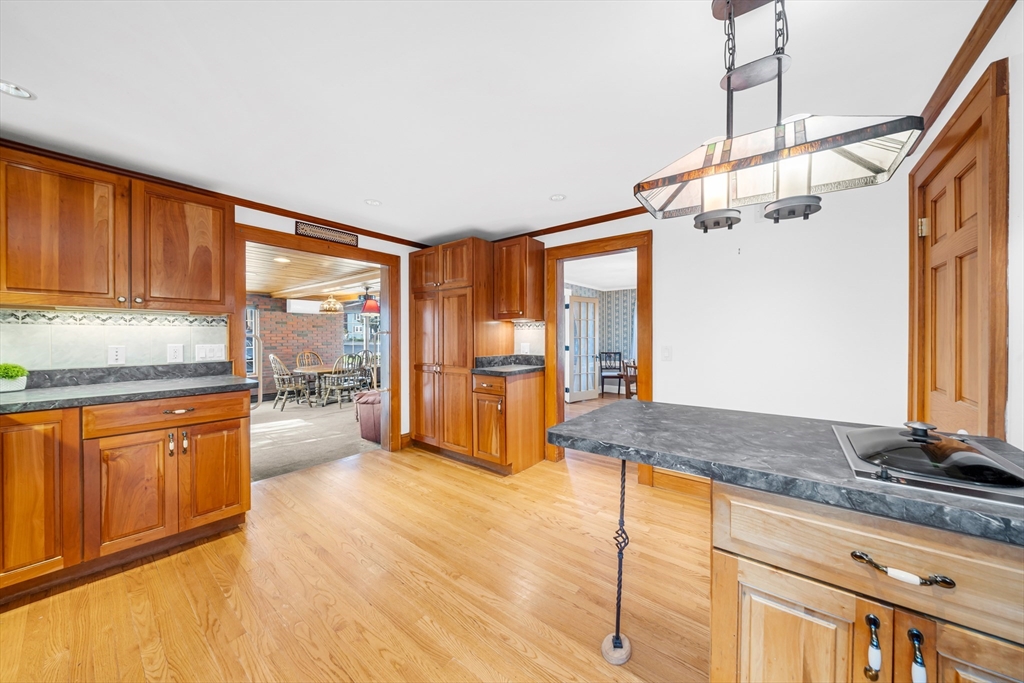 293 Florence Road Waltham, MA 02453 - Photo 9 of 41 a kitchen with stainless steel appliances granite countertop a refrigerator a sink dishwasher a stove and white countertops with wooden floor