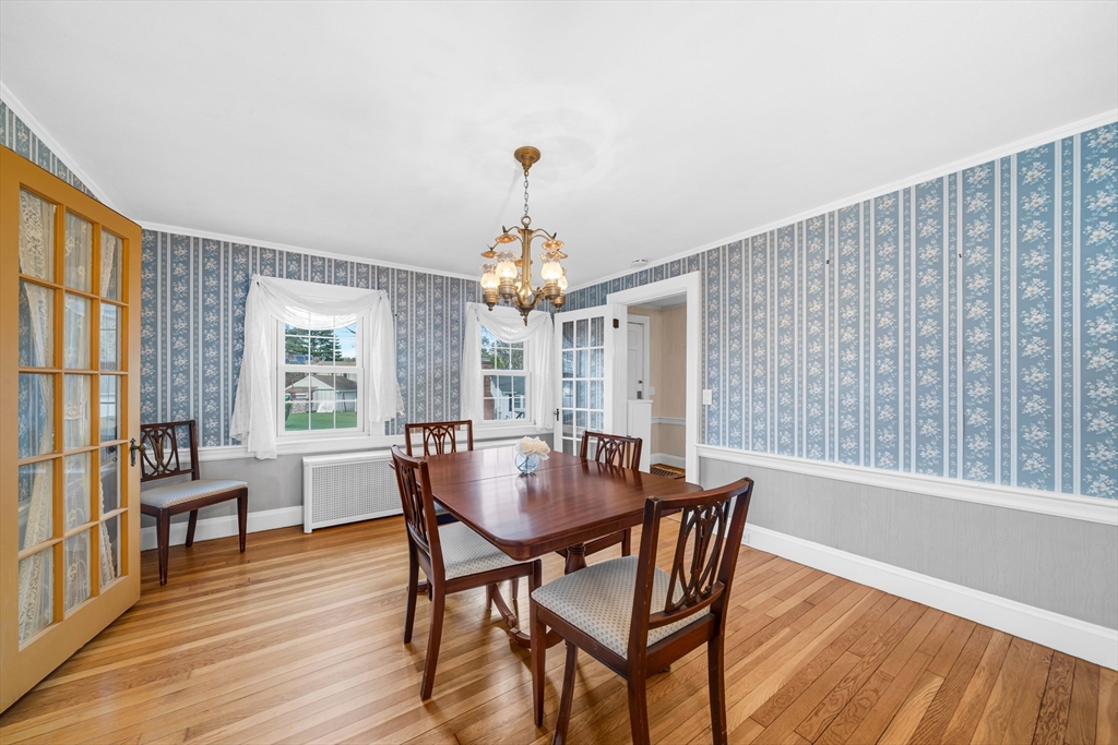 293 Florence Road Waltham, MA 02453 - Photo 10 of 41 a dining room with furniture a chandelier and wooden floor