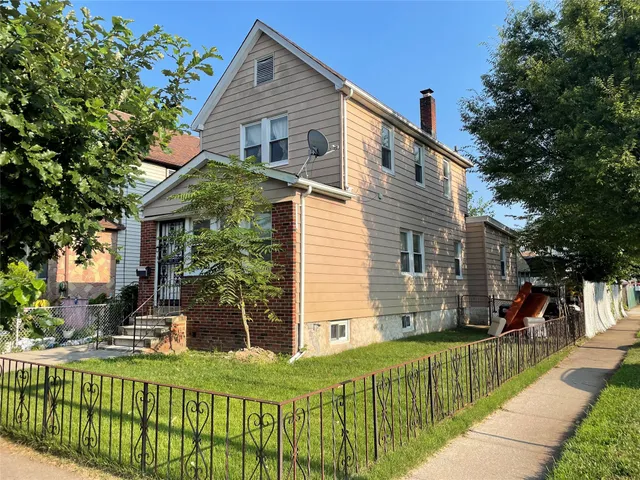 a front view of a house with a yard table and chairs
