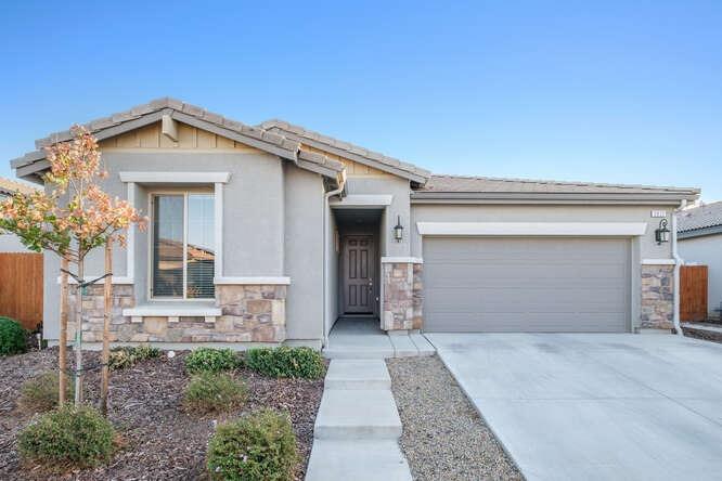 a view of a house with a yard and garage