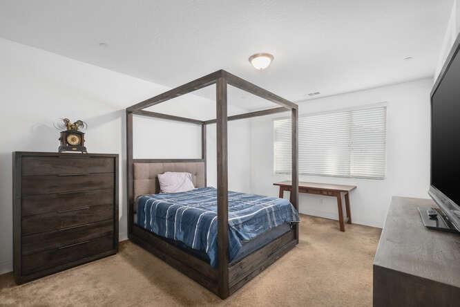 3822 Hannah Lane Clovis, CA 93619 - Photo 18 of 26 a bedroom with a bed and a flat tv screen on dresser